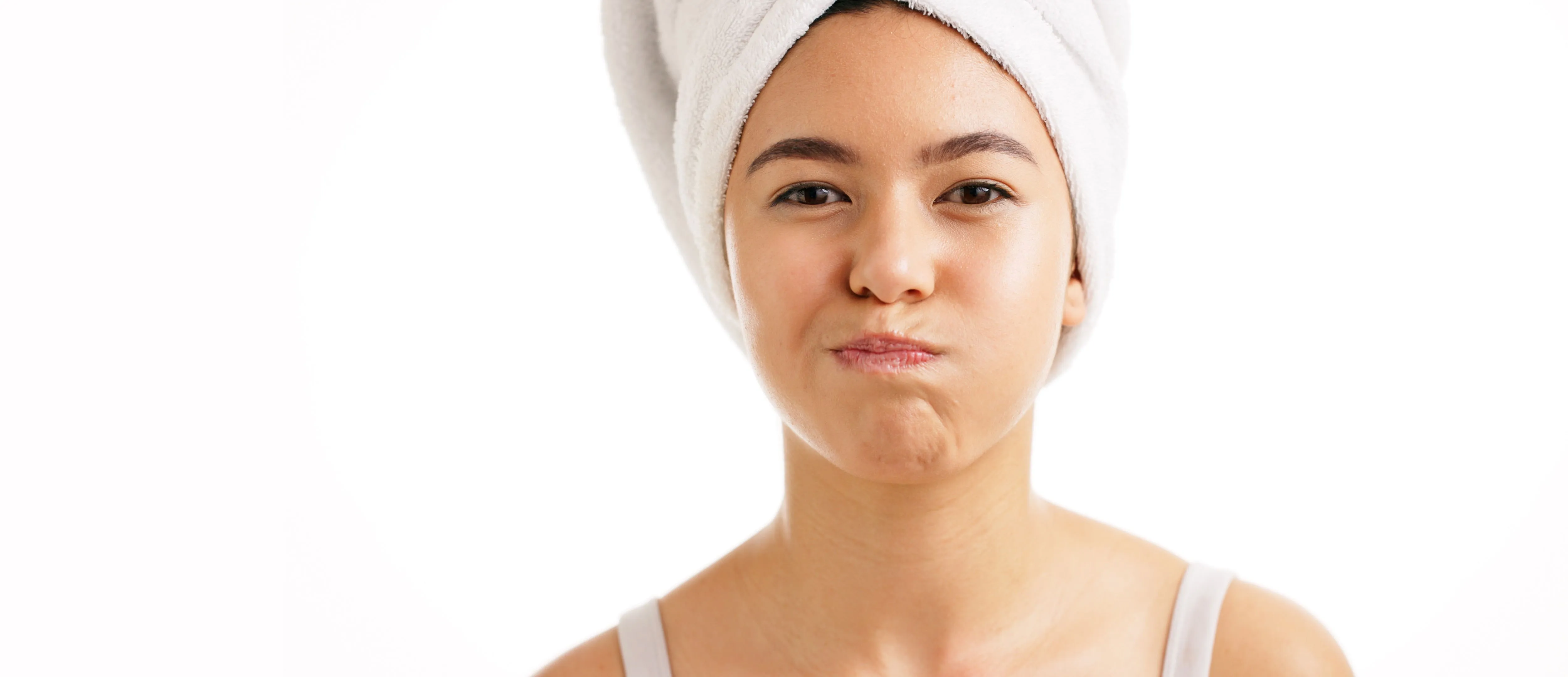 A woman with a hair towel after her oral care routine